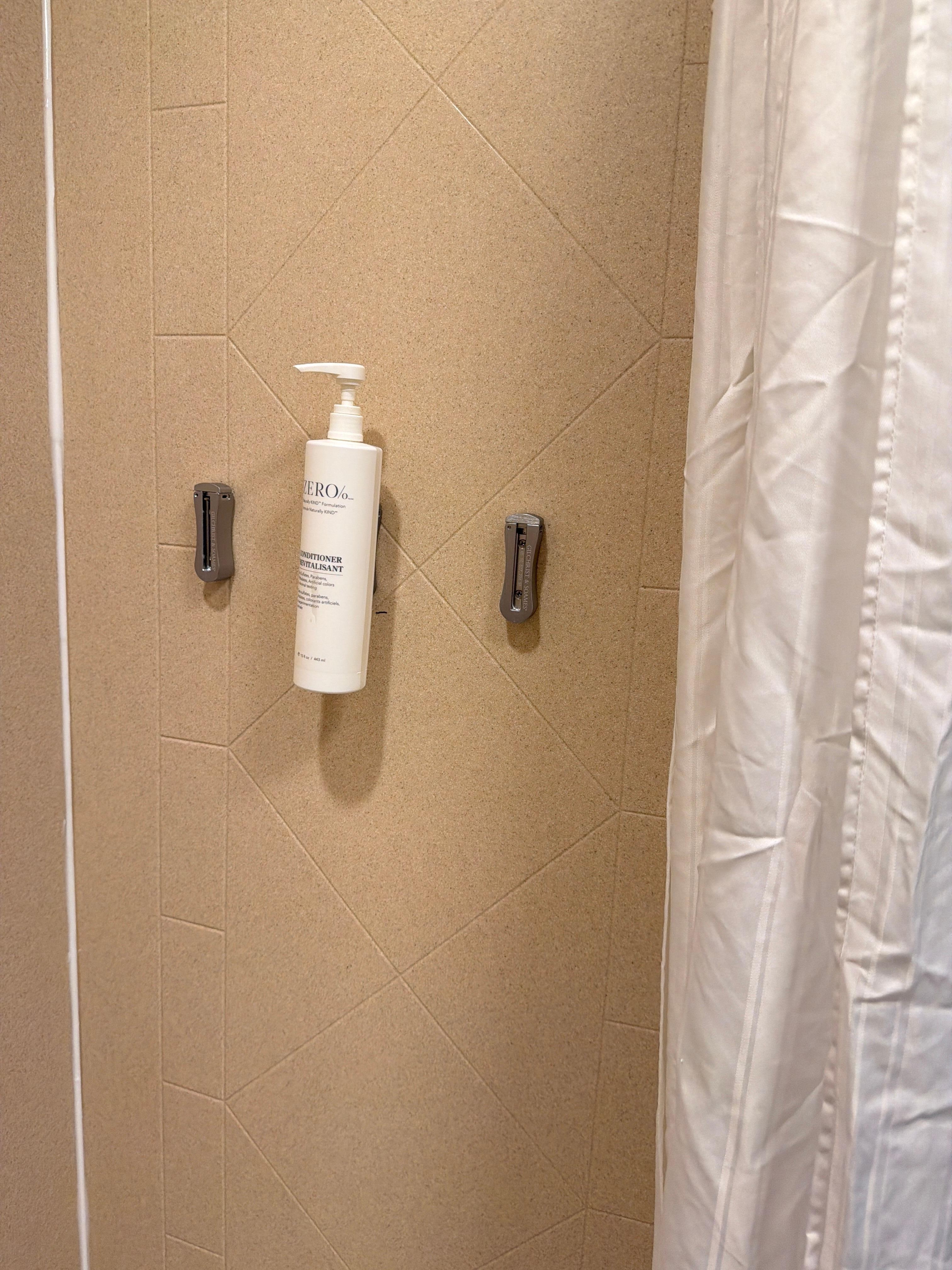 This bathroom is missing amenities that were supposed to be provided.  This is a picture of some conditioner that was left behind.