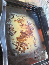 The grease left on the tray in the oven.