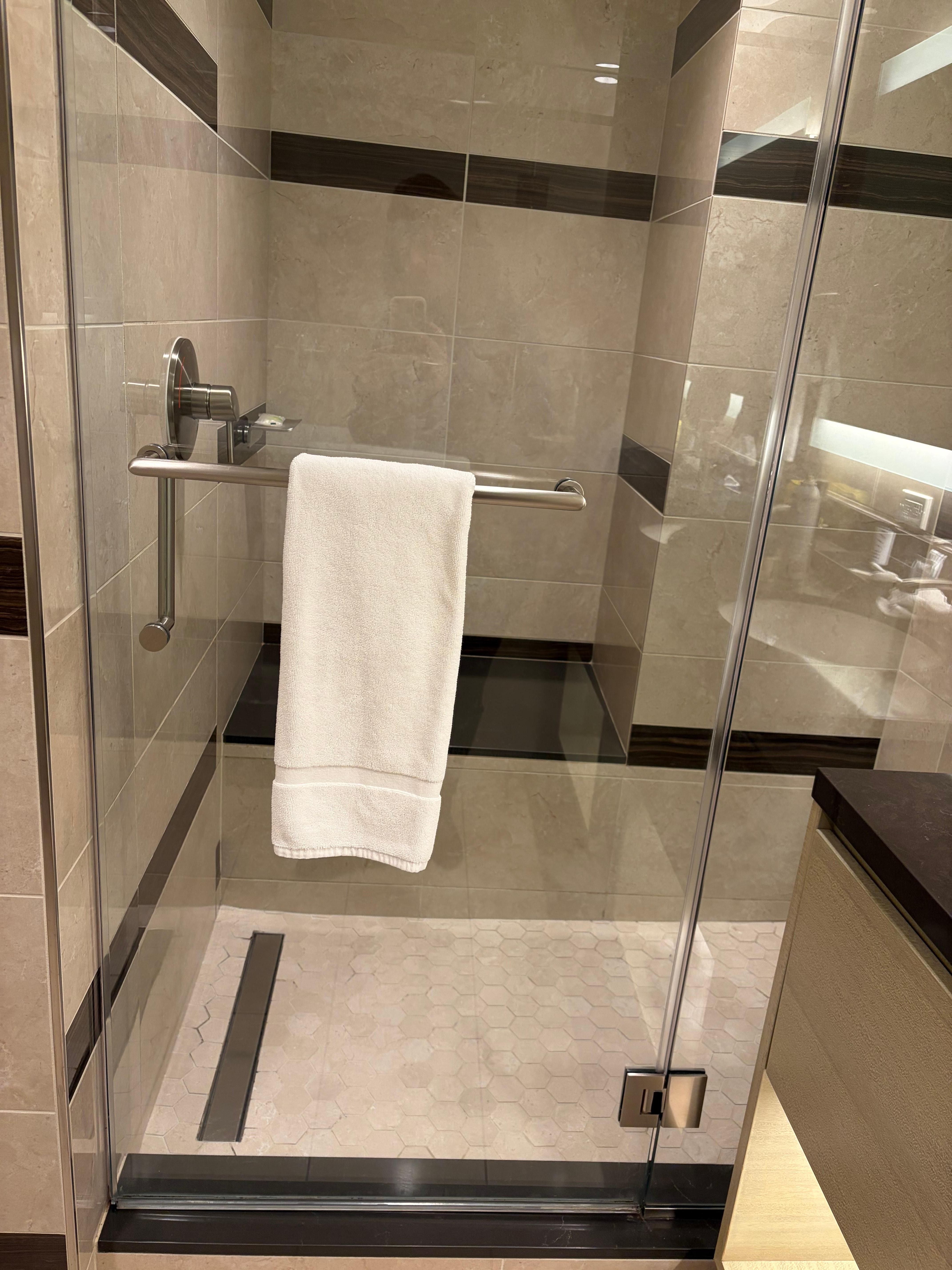 Walk in shower with glass door. 