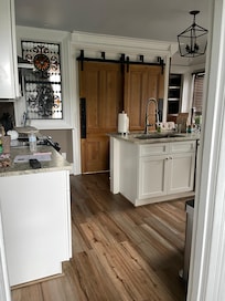 Looking at the kitchen-behind barn doors is the spacious laundry.