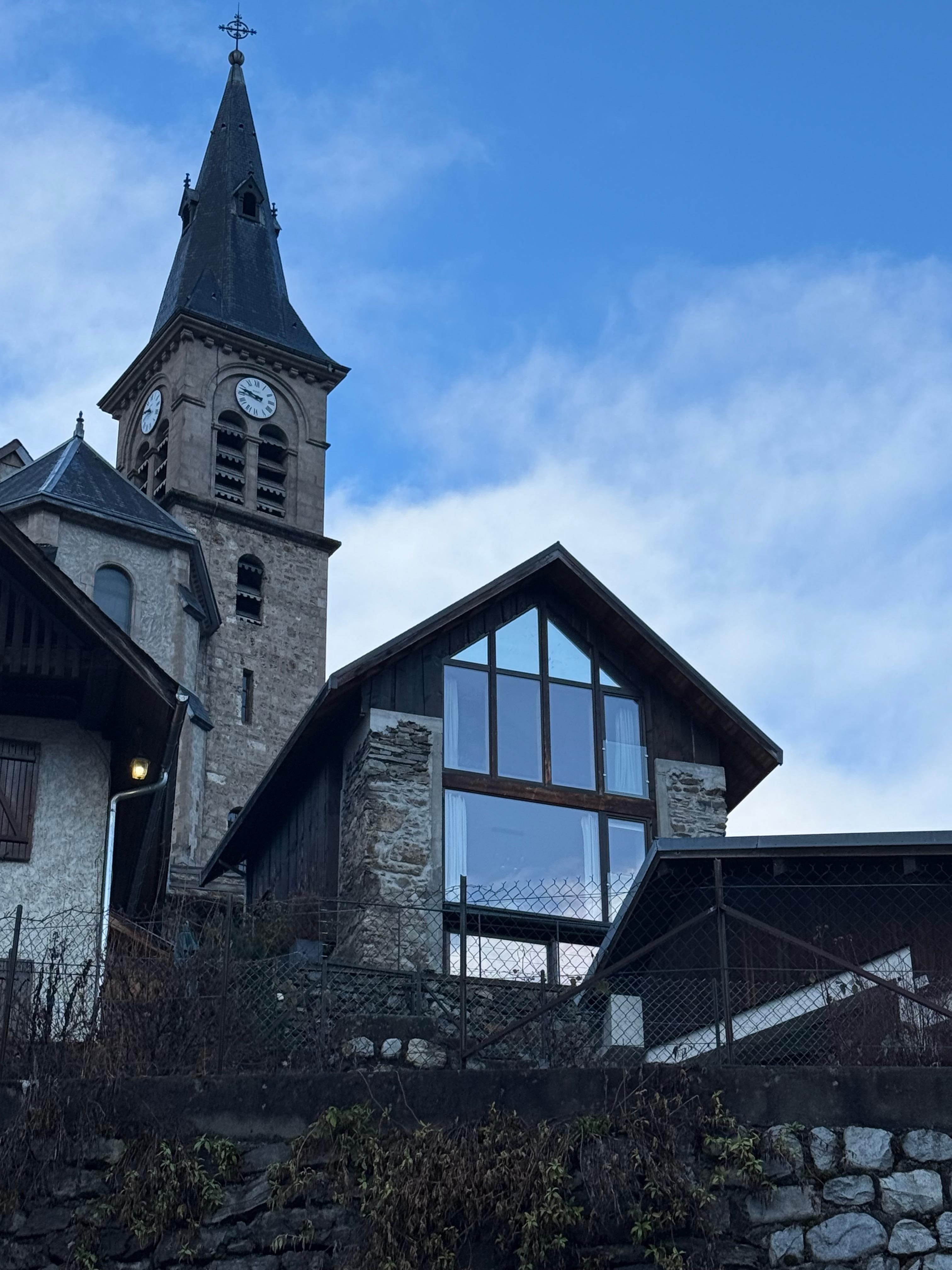 View of the chalet, 1st and 2nd floors all glass.  The church is just behind.