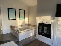 Room interior with jet tub and fireplace