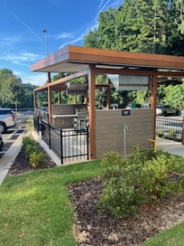 Good idea: outdoor space with picnic tables and gas grills for guest use. Less good idea: putting it in the middle of the parking lot so you have to walk from lobby.