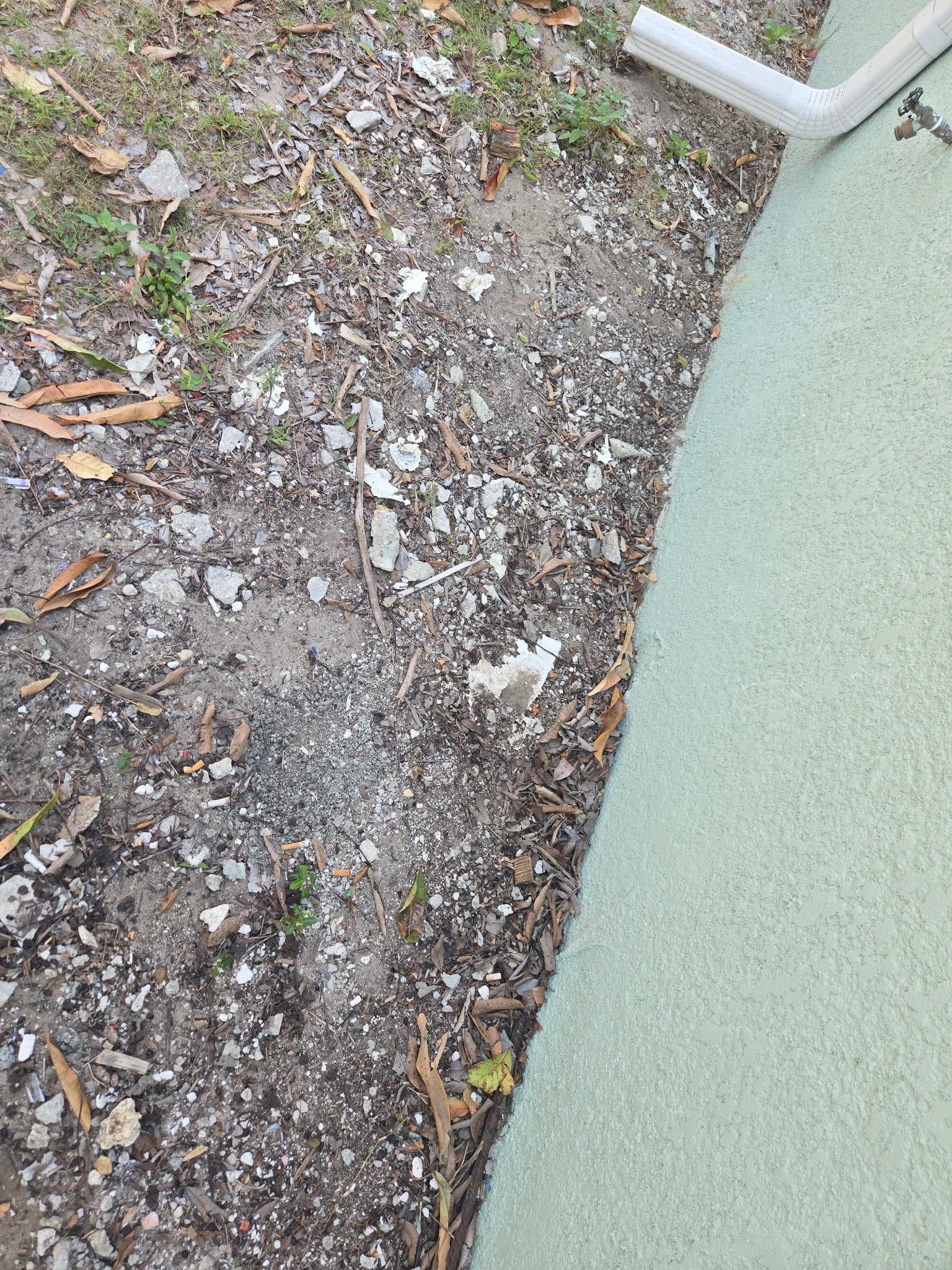 exterior plaster debris all around house