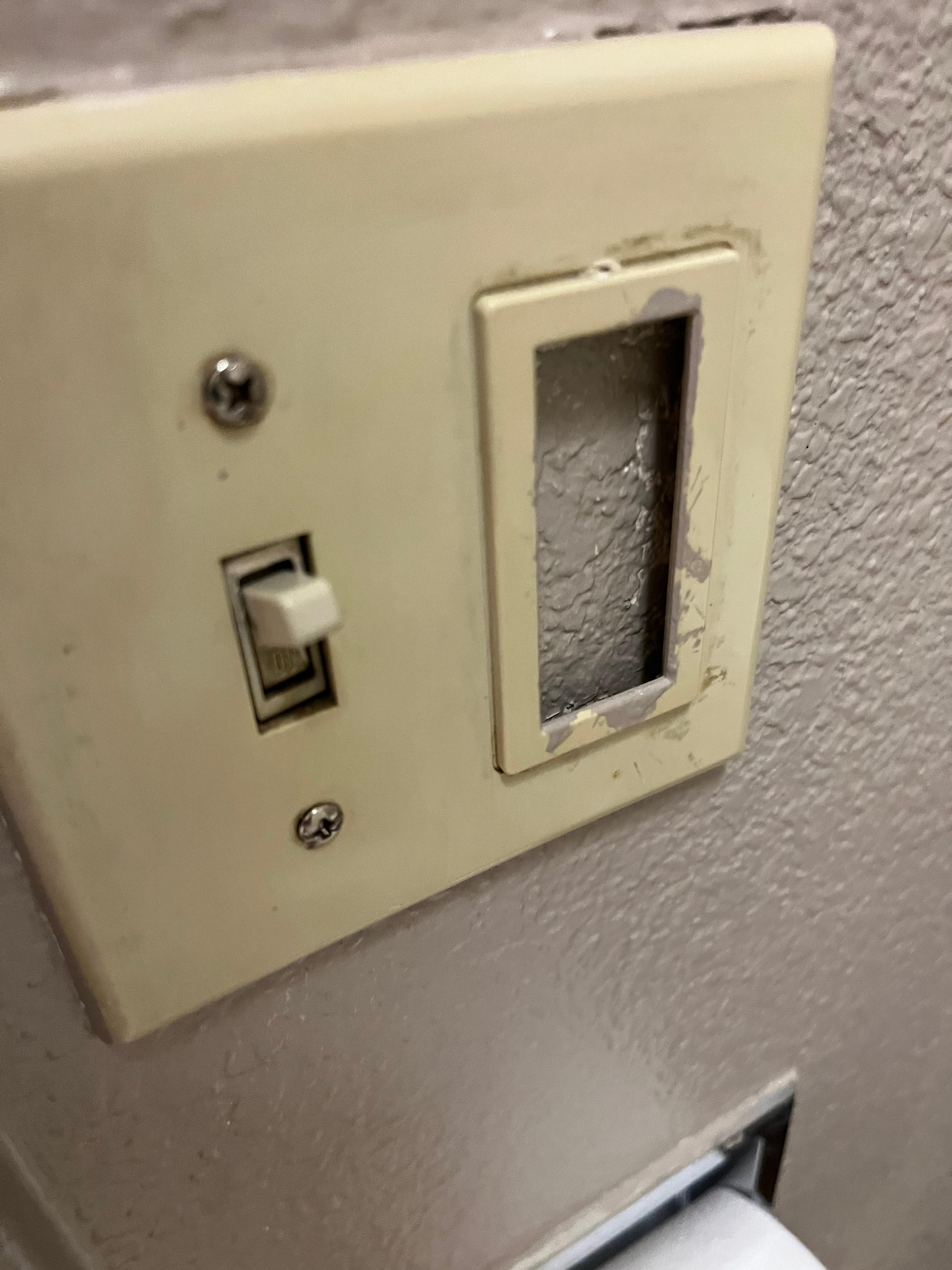 Very dirty and ridiculous switch plate - the correct plates cost less than a buck..