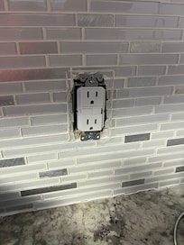 No cover on electrical outlet. Safety hazard.