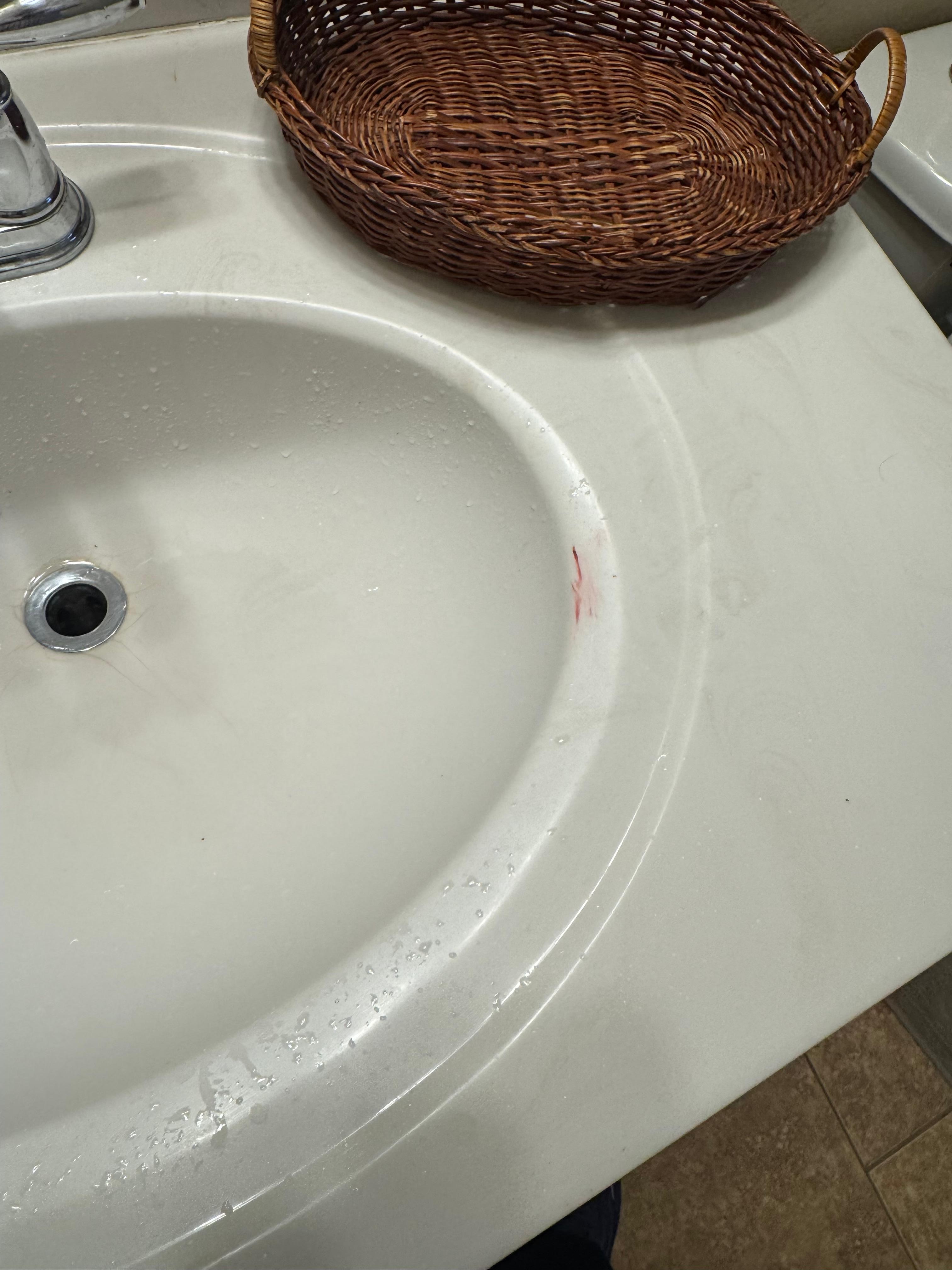 Makeup or blood on sink in bathroom 