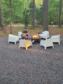 Kids enjoying the outdoors next to the fire.