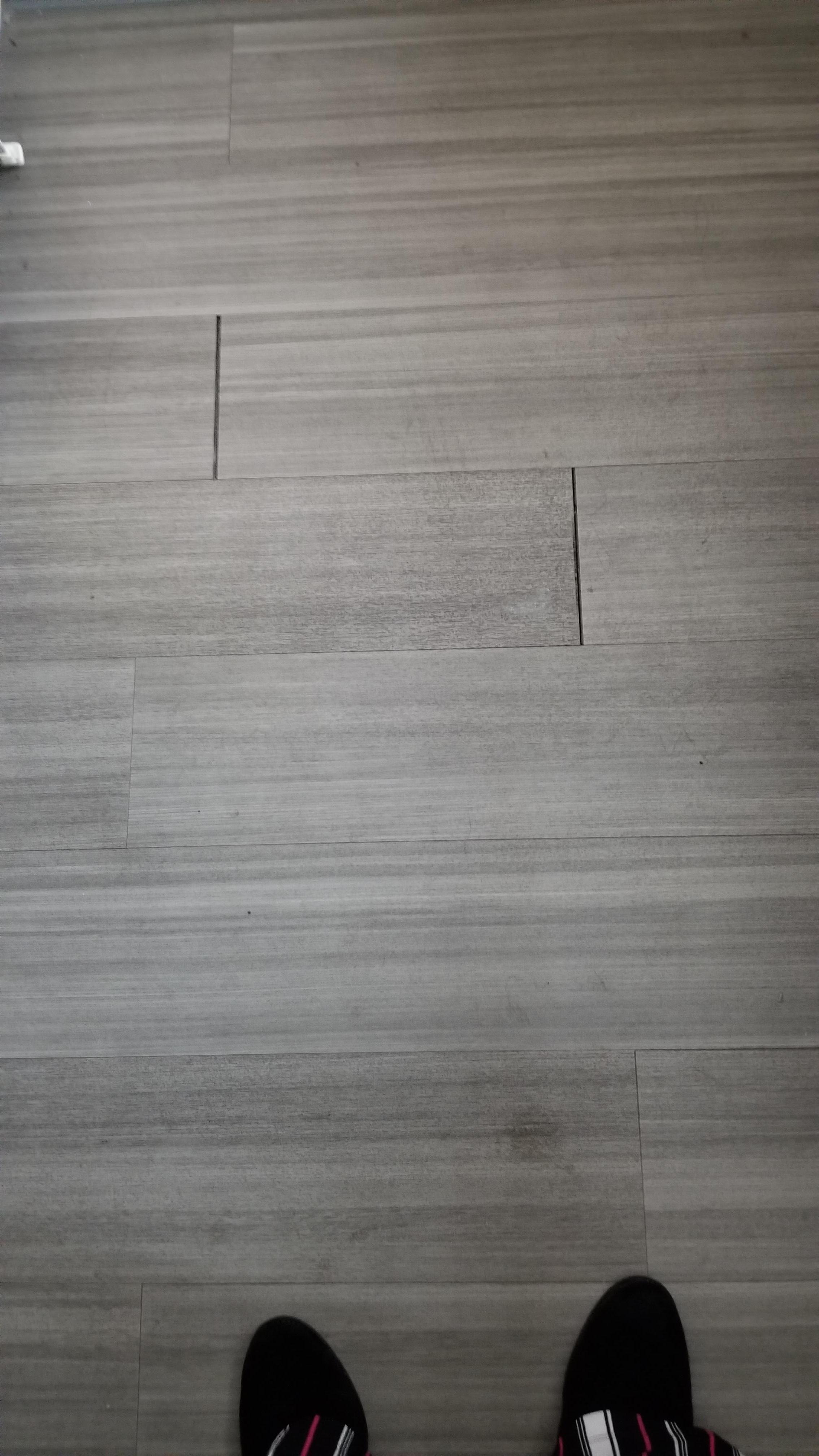 Separated flooring creating slip/trip/fall hazard