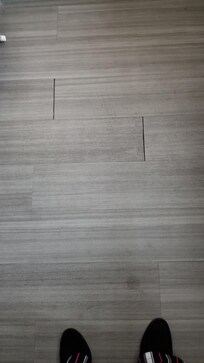 Separated flooring creating slip/trip/fall hazard