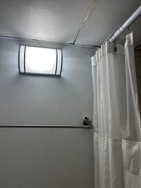 The towel rack is coming out of the wall.