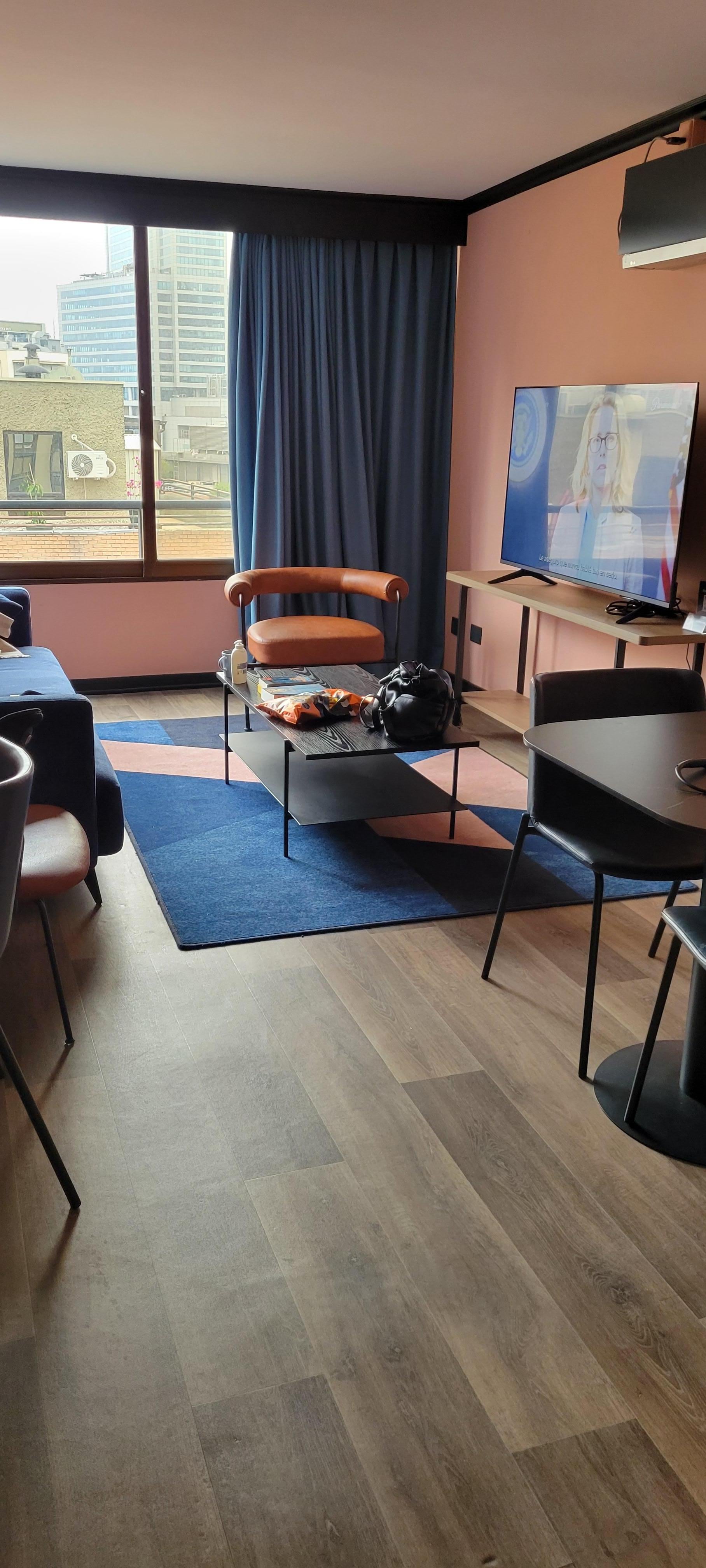 Living Room with large screen TV and balcony