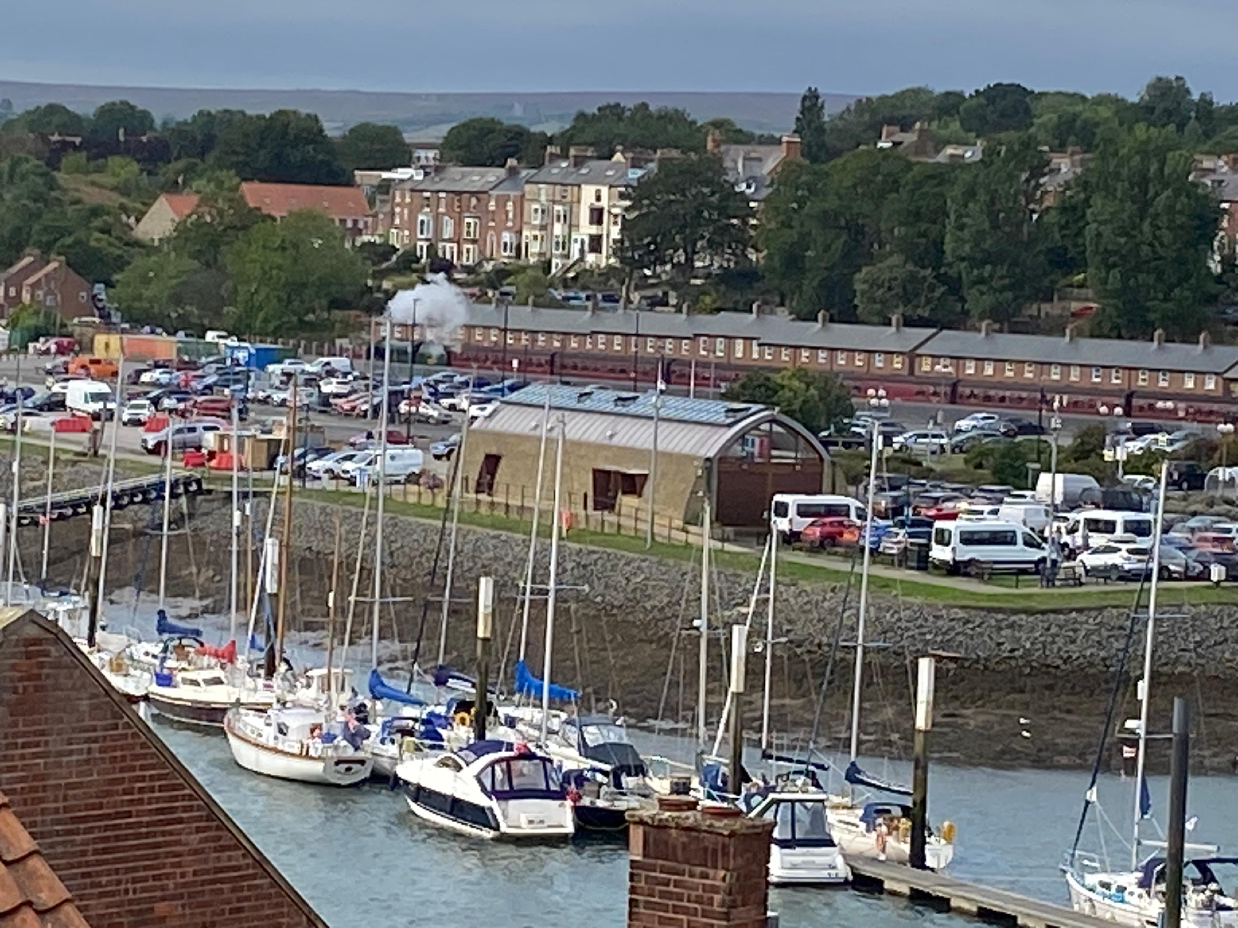 Photo taken from window, steam train visible. 😊