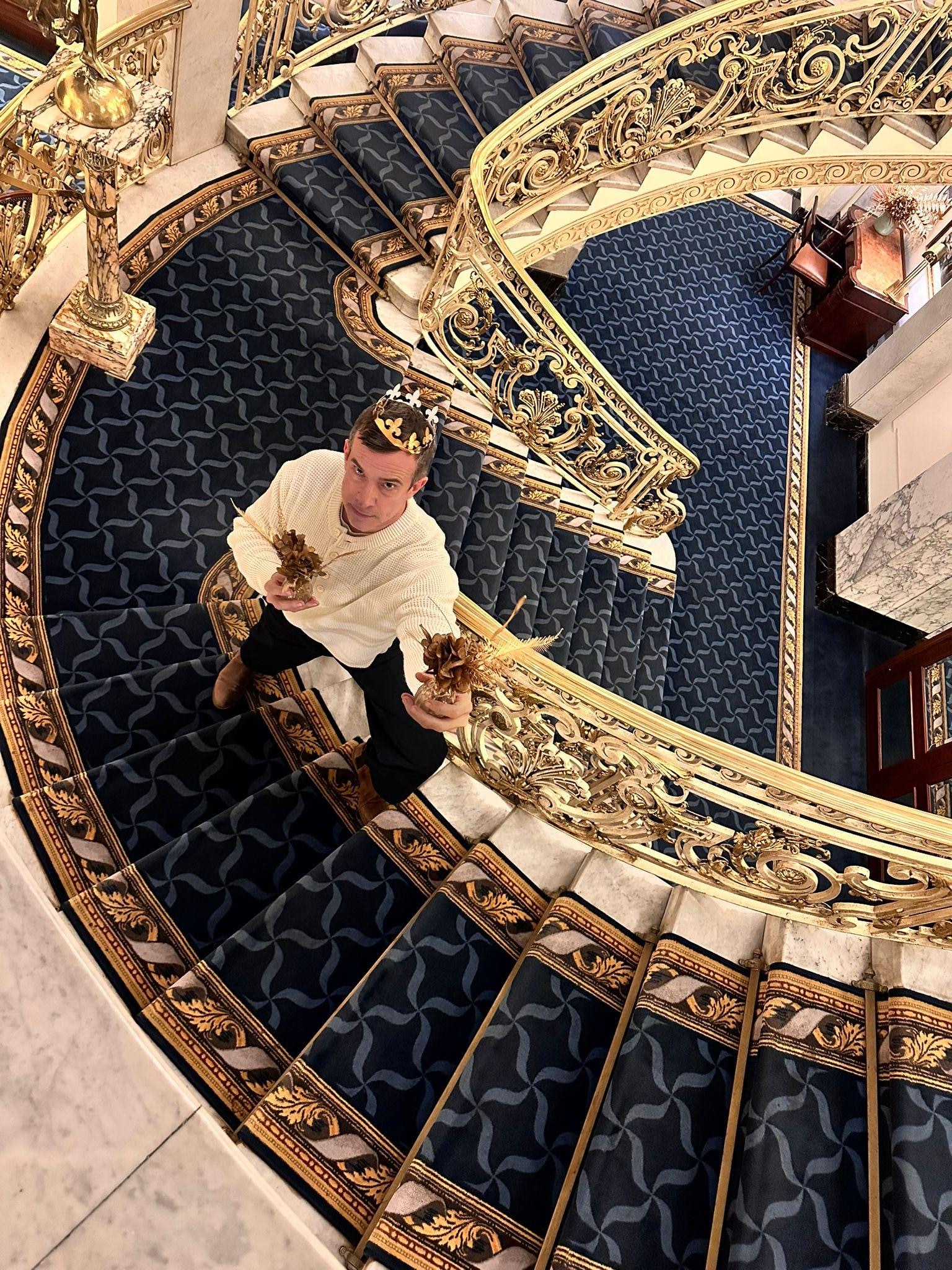 My friend streaks a pose in the beautiful staircase 