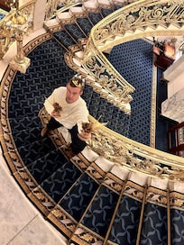 My friend streaks a pose in the beautiful staircase