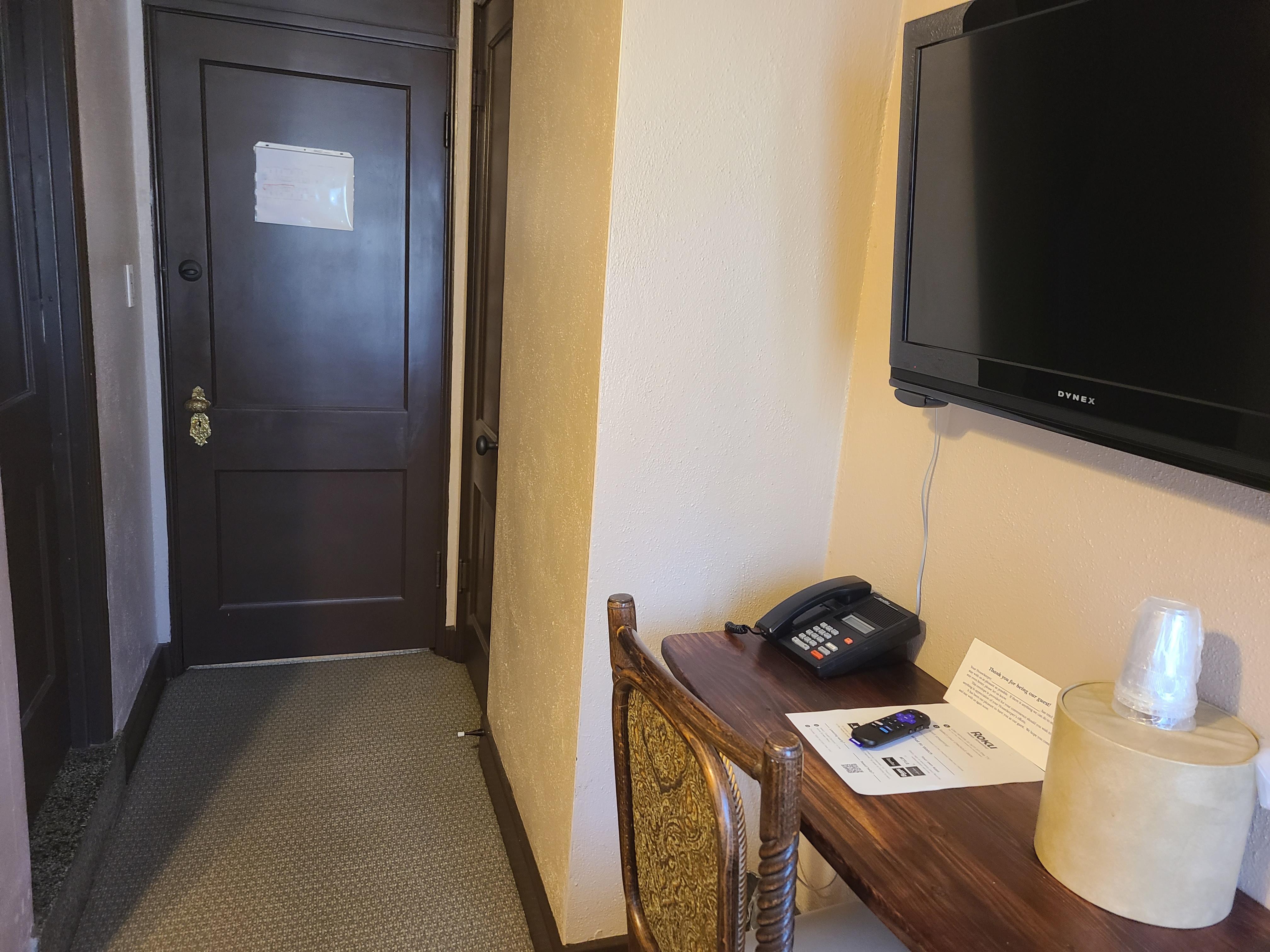 Desk in the room and door to the hallway
