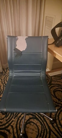 Torn up desk chair. It was replaced upon my request.