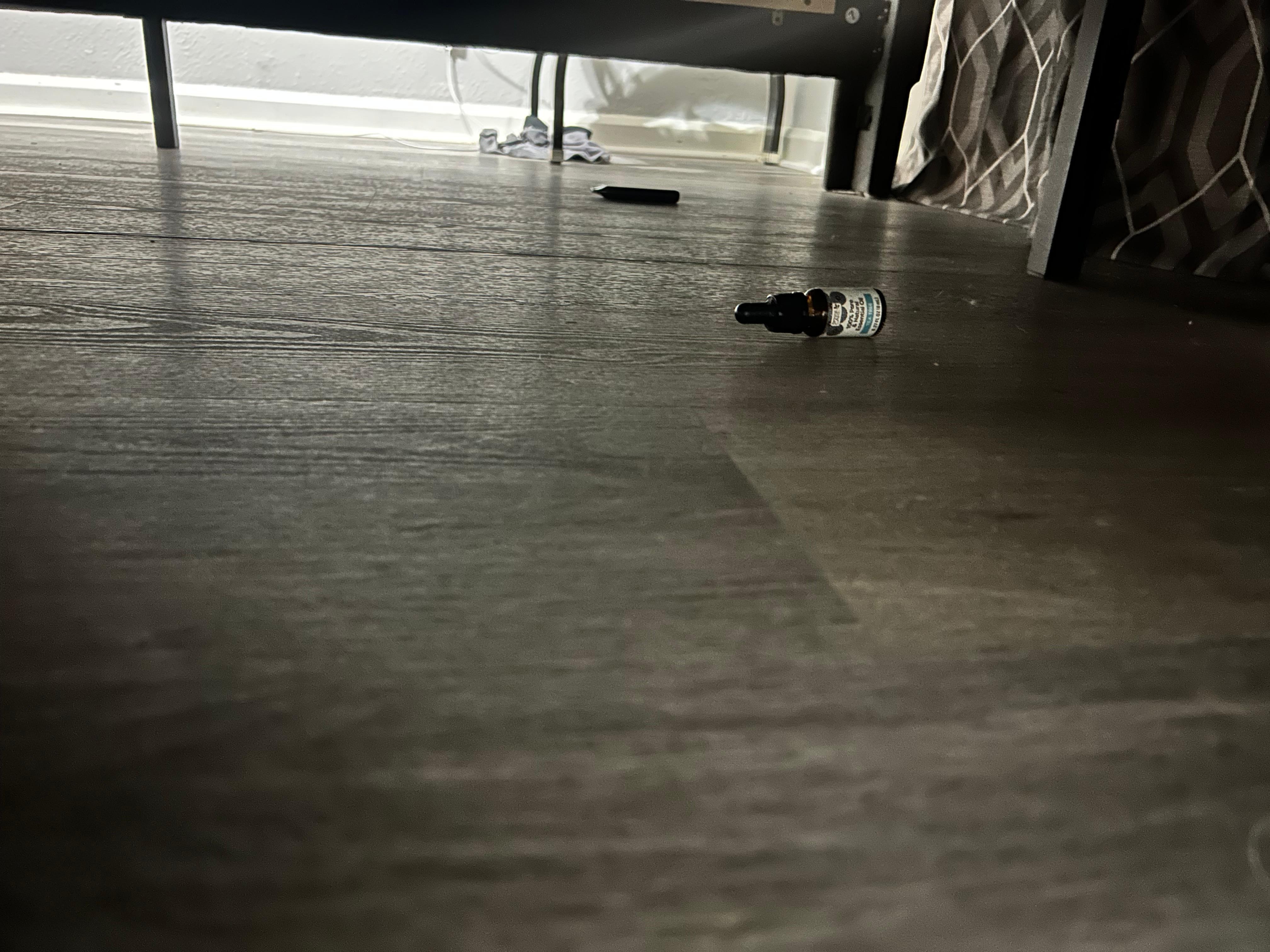 Vape and bottle under the bed