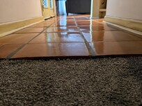 Trip hazard with large lip from bedroom to living area due to no transition piece.