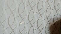 Wallpaper worn down from chair