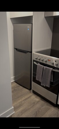 Kitchen with a nice sized fridge and stove