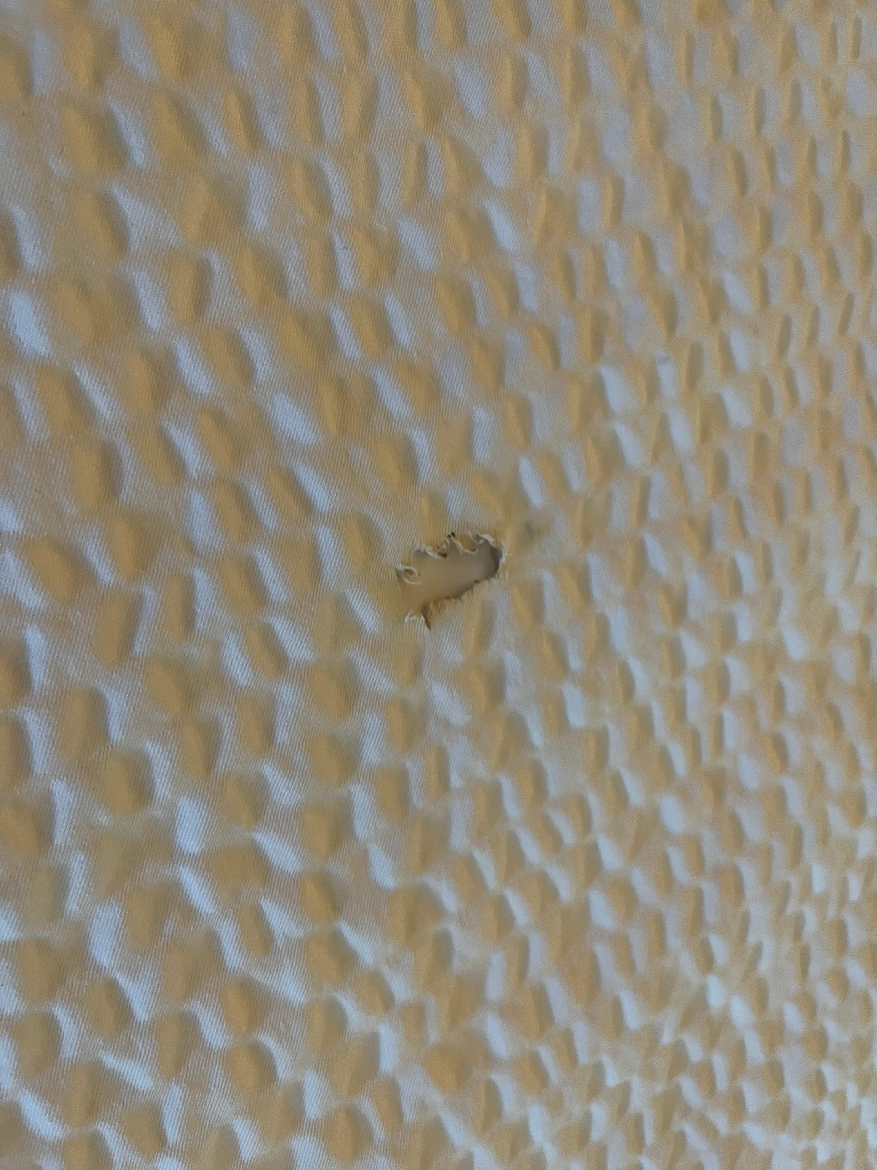Bedspread with cigarette burns 