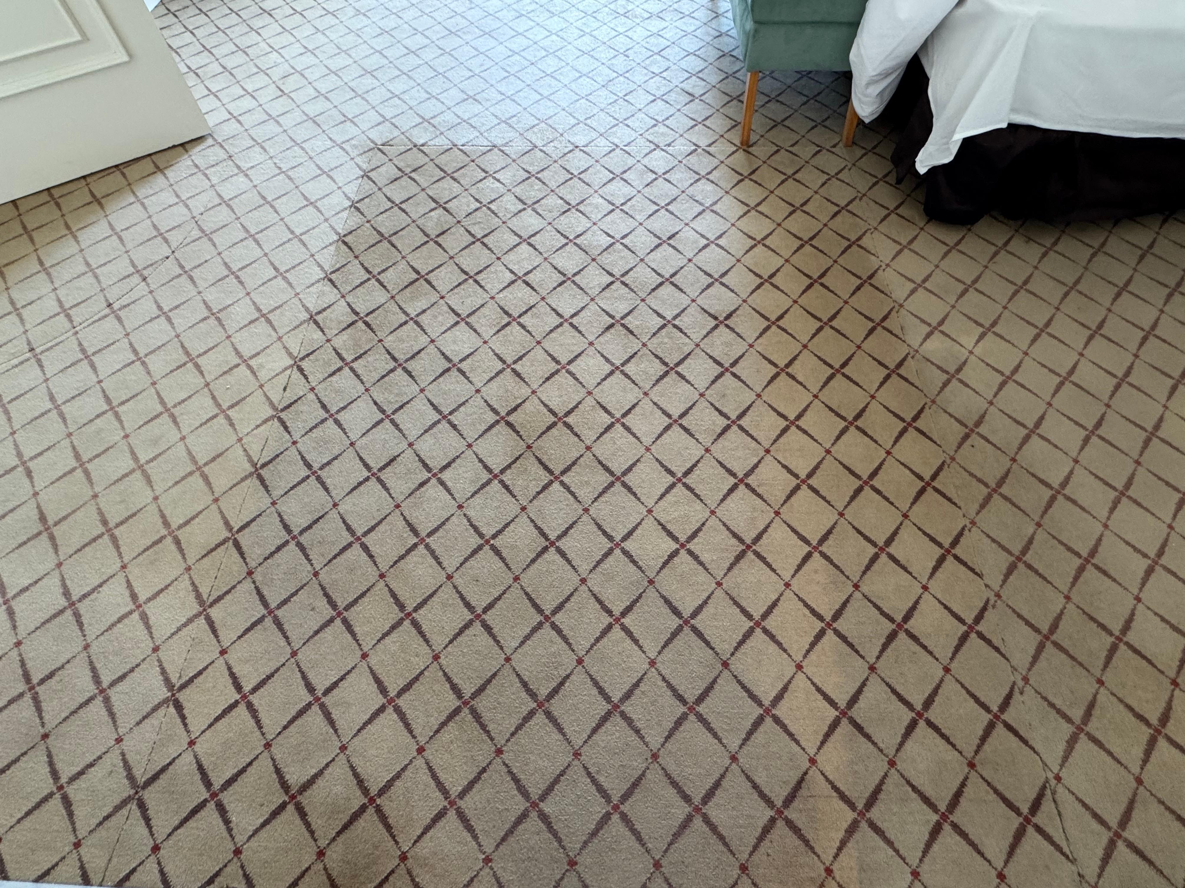 Cut and patched carpet in Presidential Suite