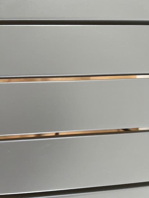 Wide gaps between slats of metal "dining" table meant crumbs and drips went everywhere.