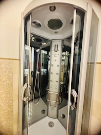Shower with multi jet outlets, lights, and music