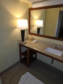 Lamp on sink because lamp on sink because the light over the mirror did not work. Someone could be electrocuted.