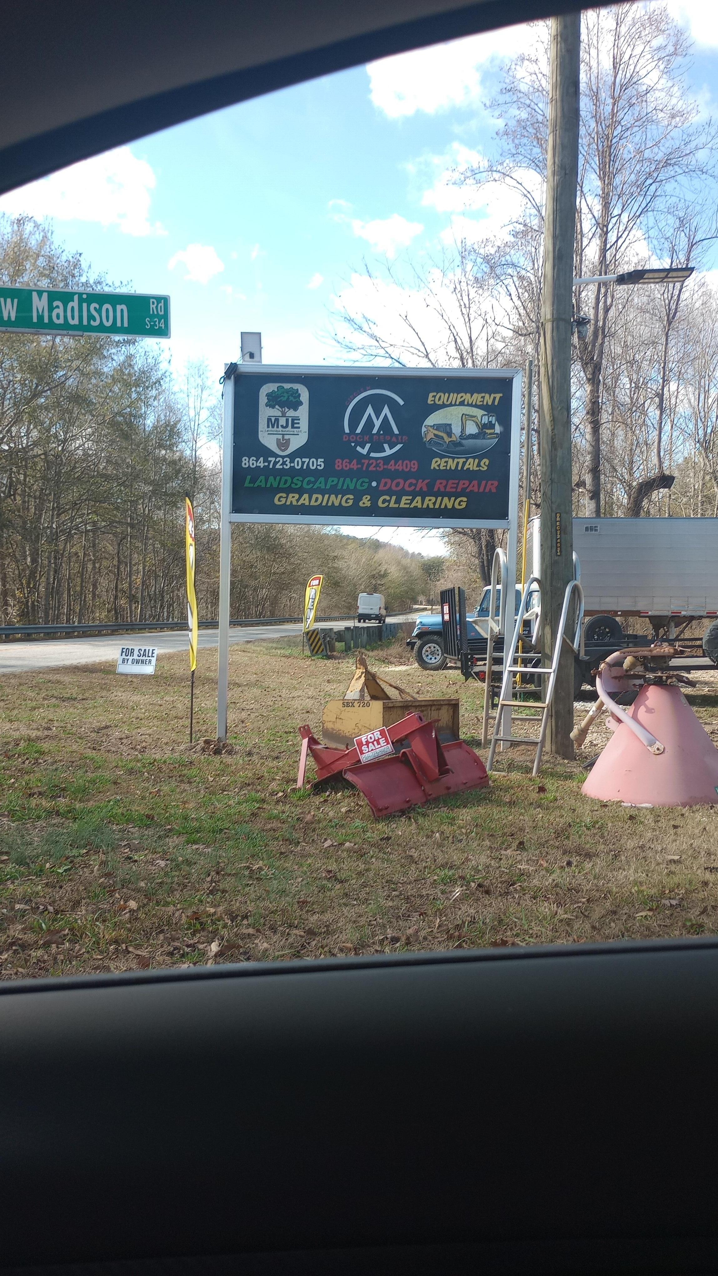 Roadside sign, you will turn here, then turn right, onto gravel lot, before following the gravel road down towards the left. 