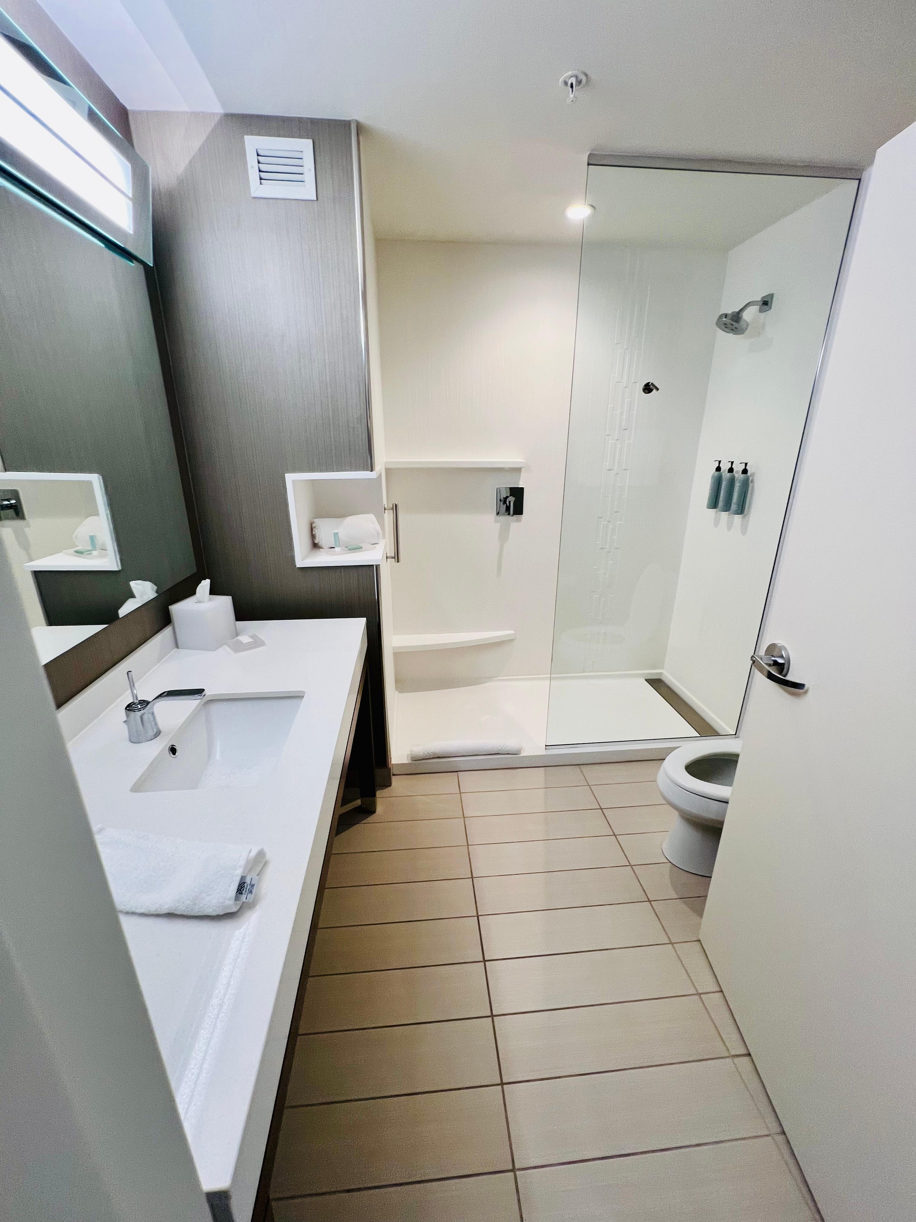 Clean bathroom with spacious shower.