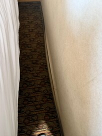 Carpet peeling away from wall