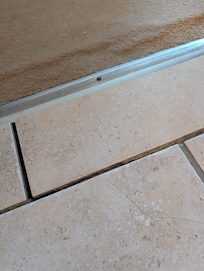 Loose tiles on bathroom entrance