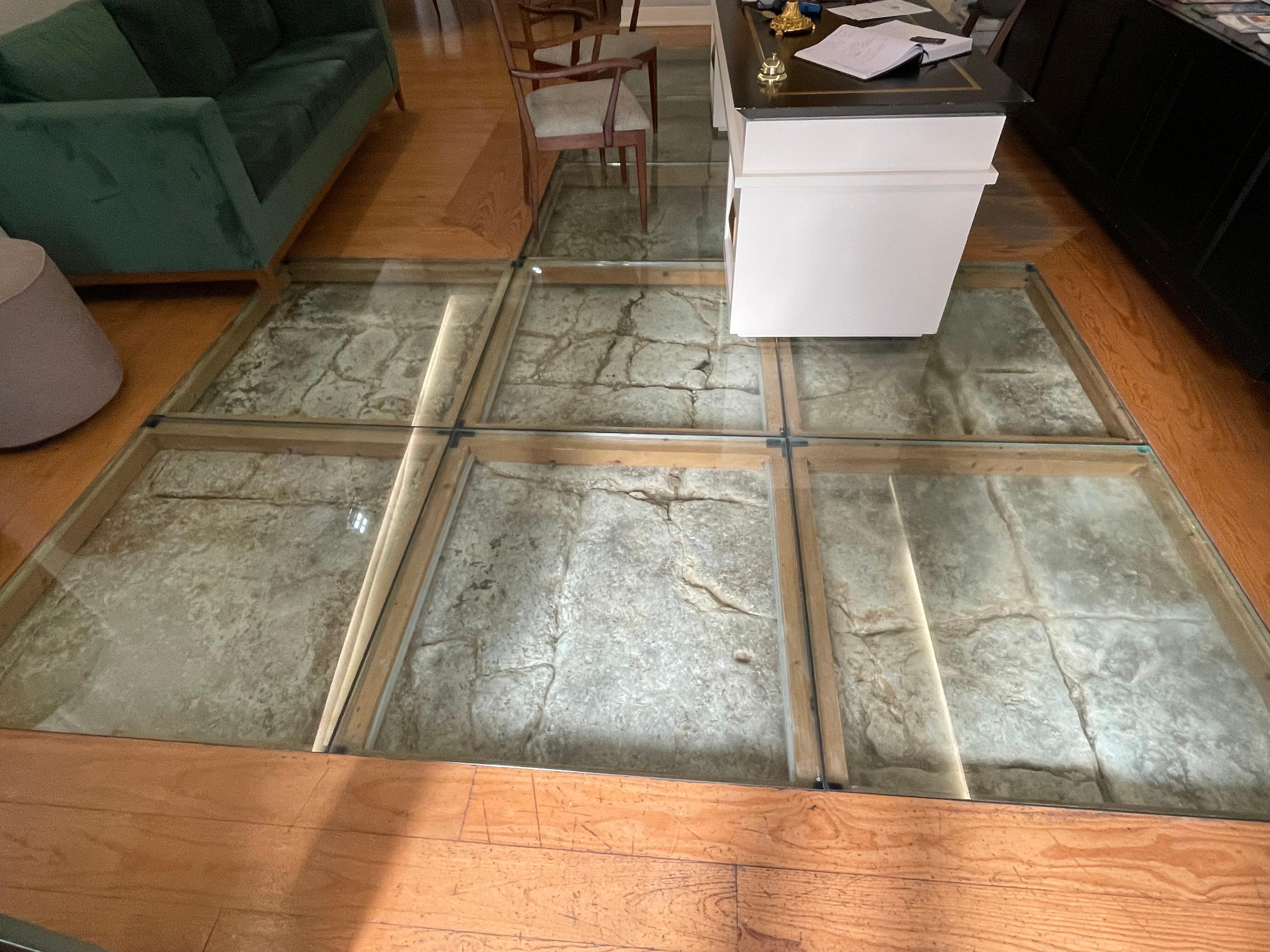 Lobby original stone floor  under glass. 