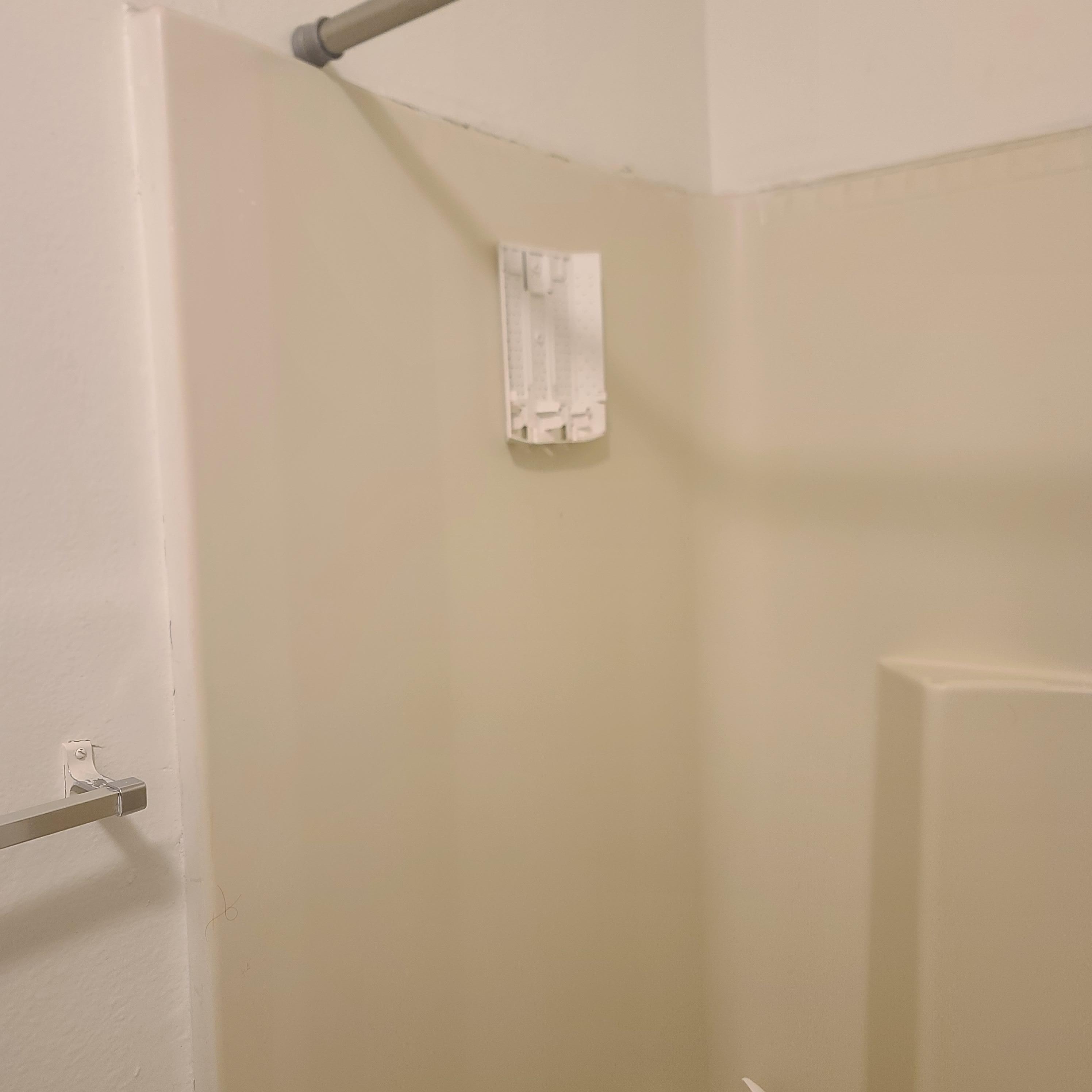 Soap dispenser in shower is missing pieces and broken