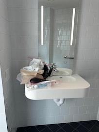 This is the sink- this is all the room you get in the bathroom to hold your essentials AND the hand towels which do not get to dry off when wet.