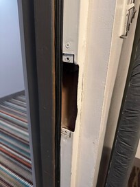 No strike plate or hardware for the lock to click into.