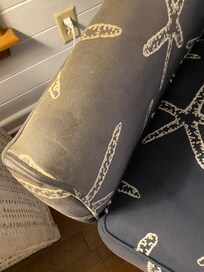 Dirty chairs in living area. Faded but also sort of sticky and dirty.