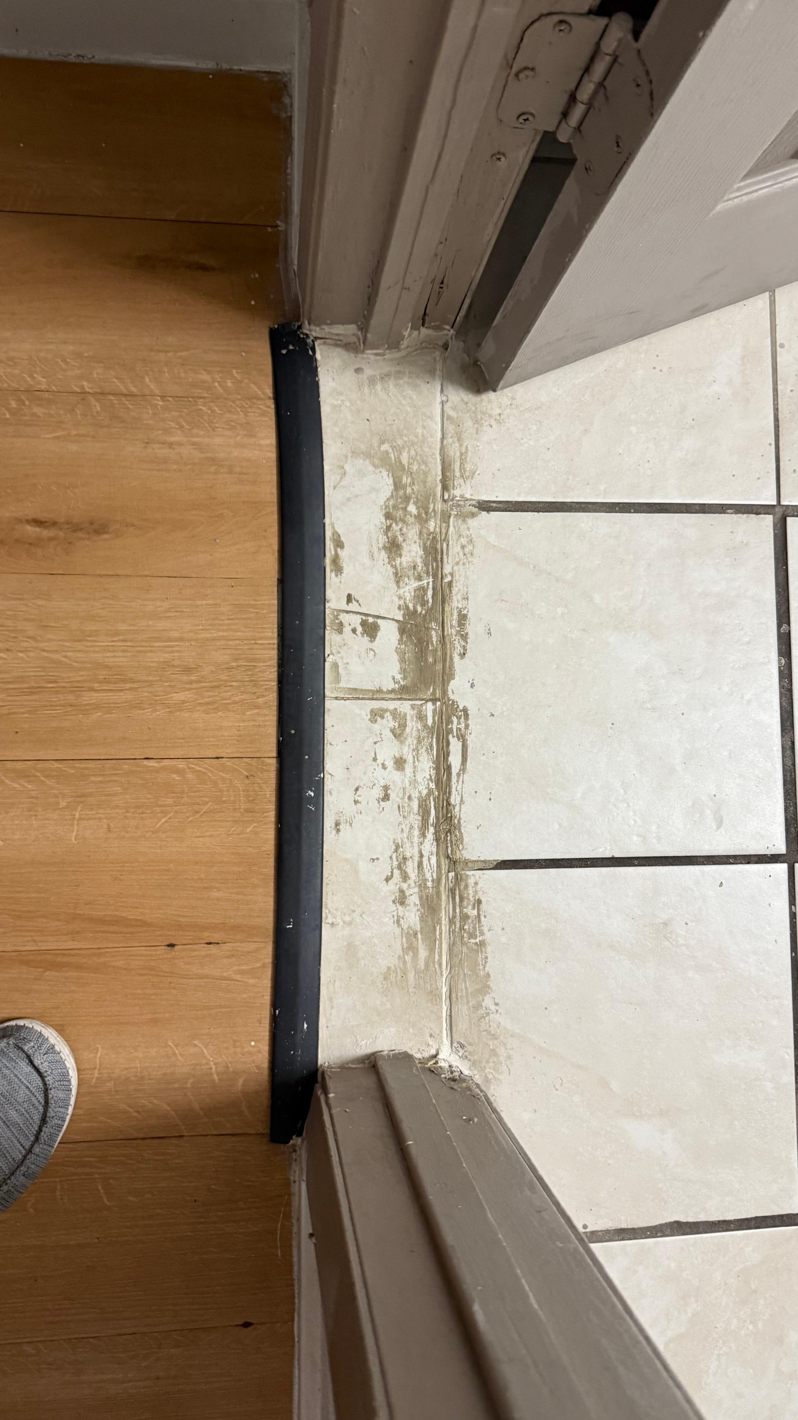 This is the threshold into the bathroom. They used caulking in this area, and the dirt build up is gross. 