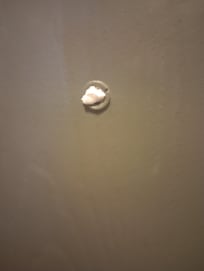 The hole to look out the door has putty over it