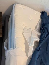 Torn, plastic mattress covers on unsupportive mattress. They crinkle when you in bed, like an empty bag of tortilla/potatoe chips
