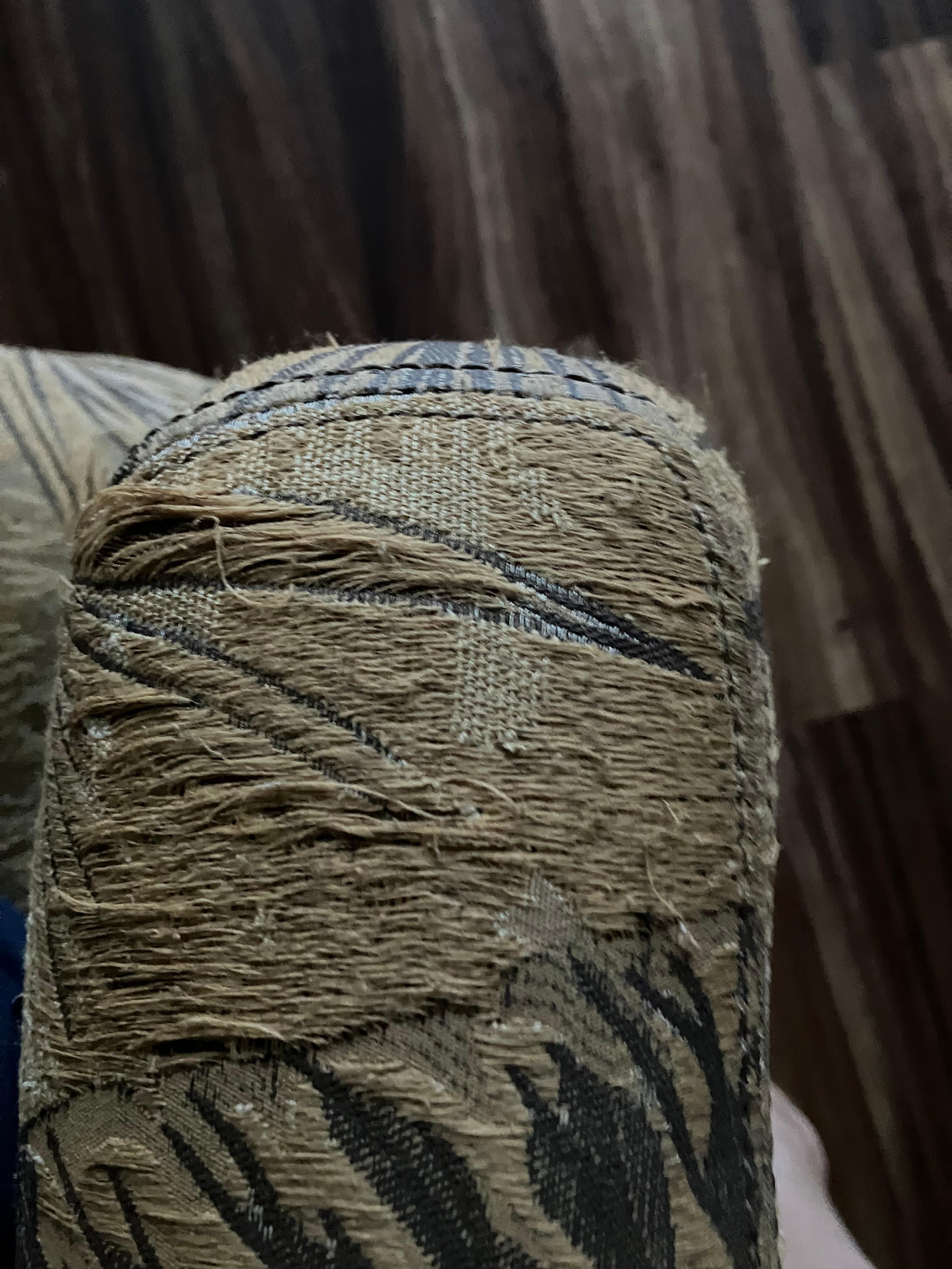 Worn out couch with fraying thread