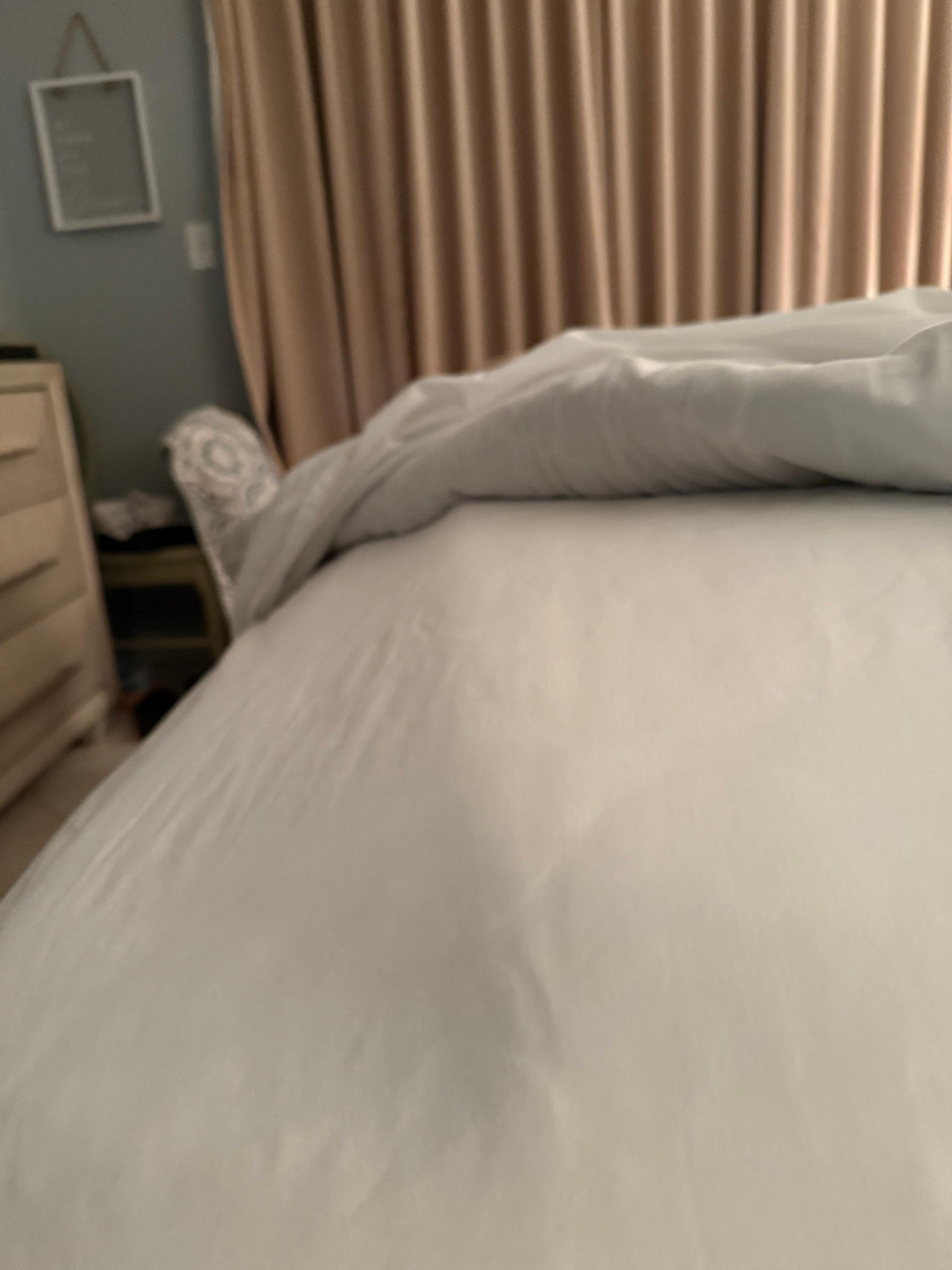 The foot of the bed where the topper ends. 