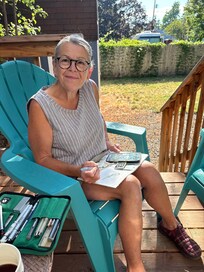 Kathy sketching on the back deck in the morning.