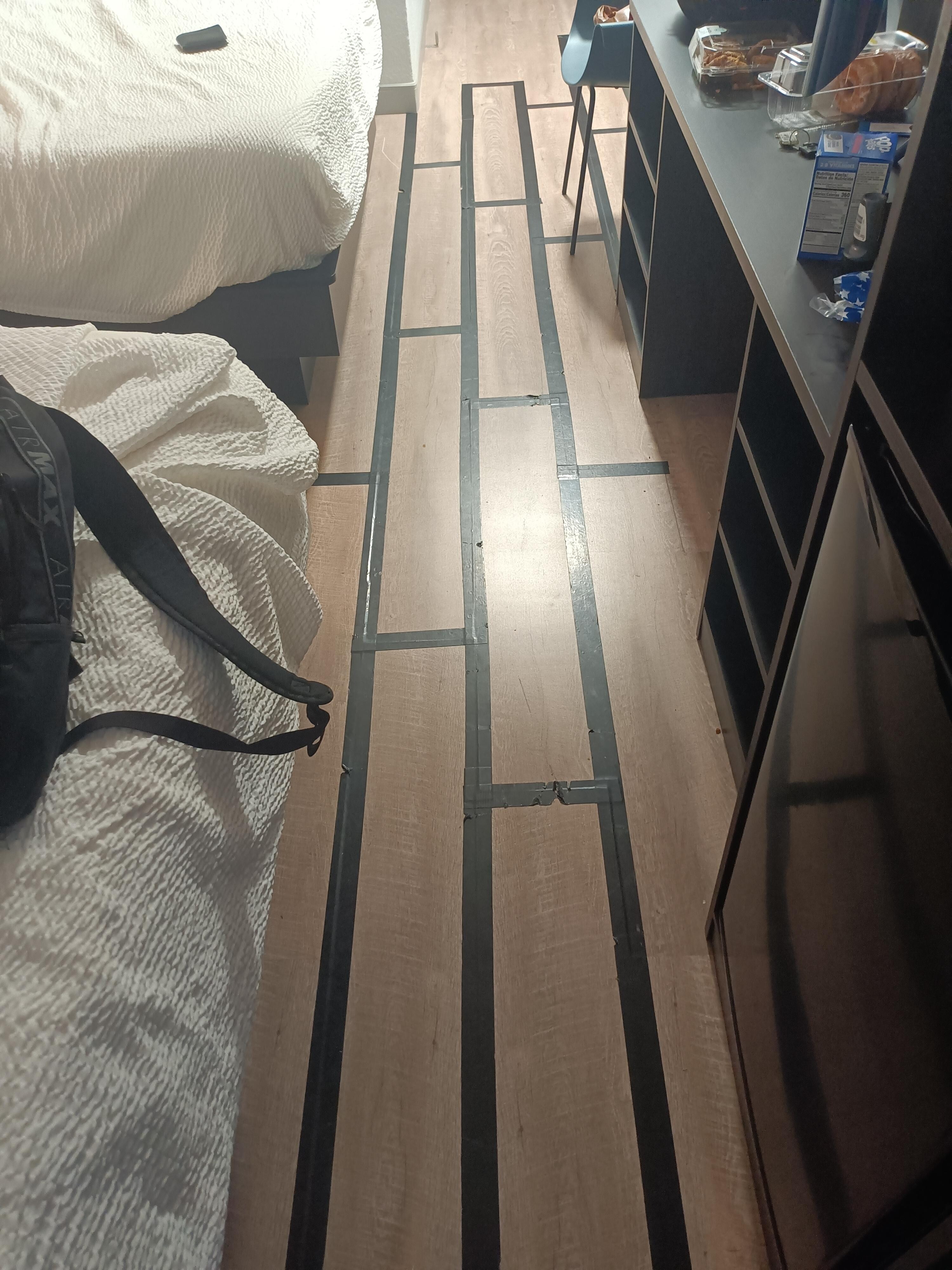 black tape holding floorboards together