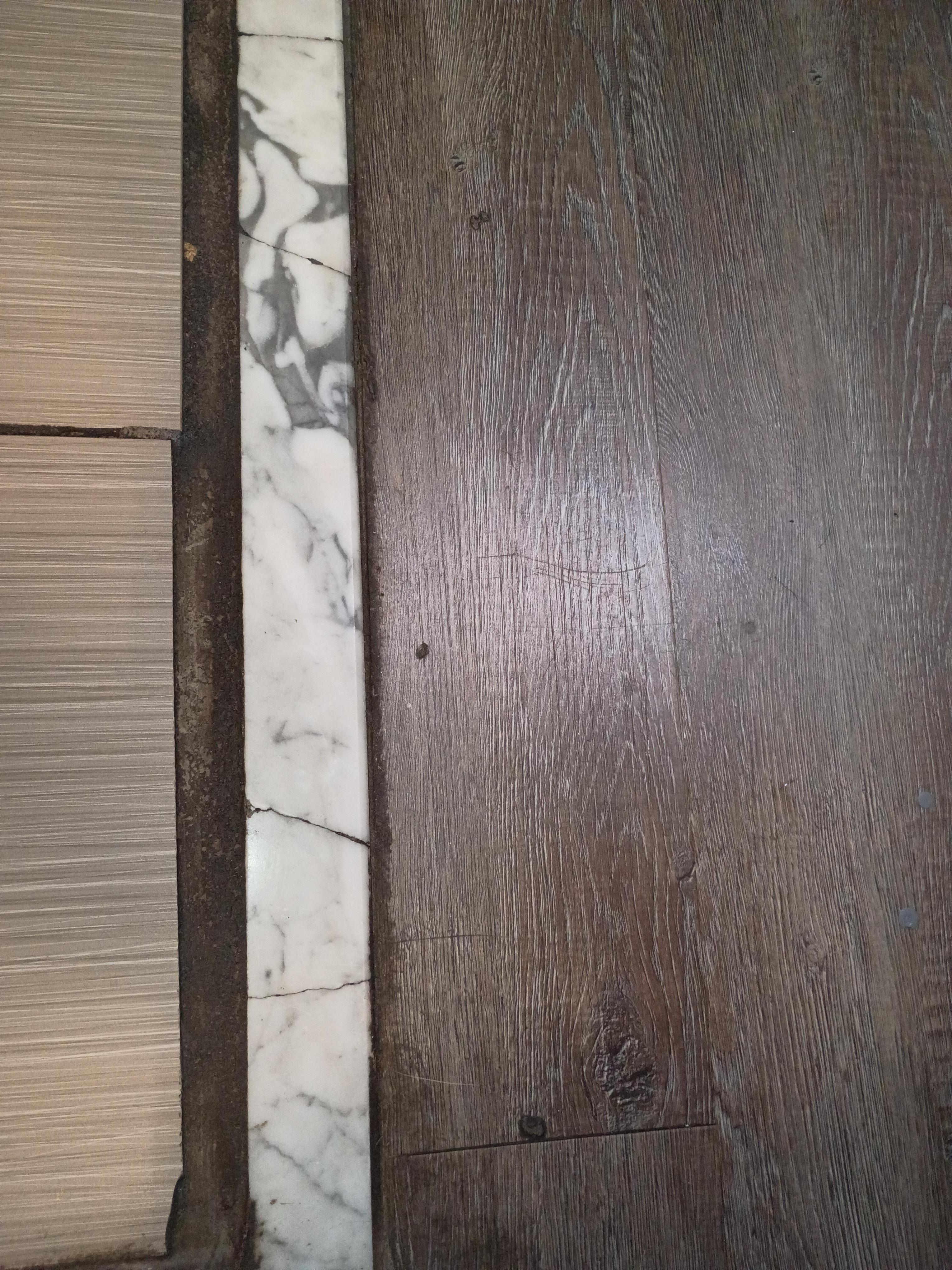 Flaking black grout.