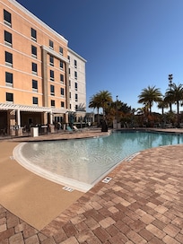 Pool area that has a bar.