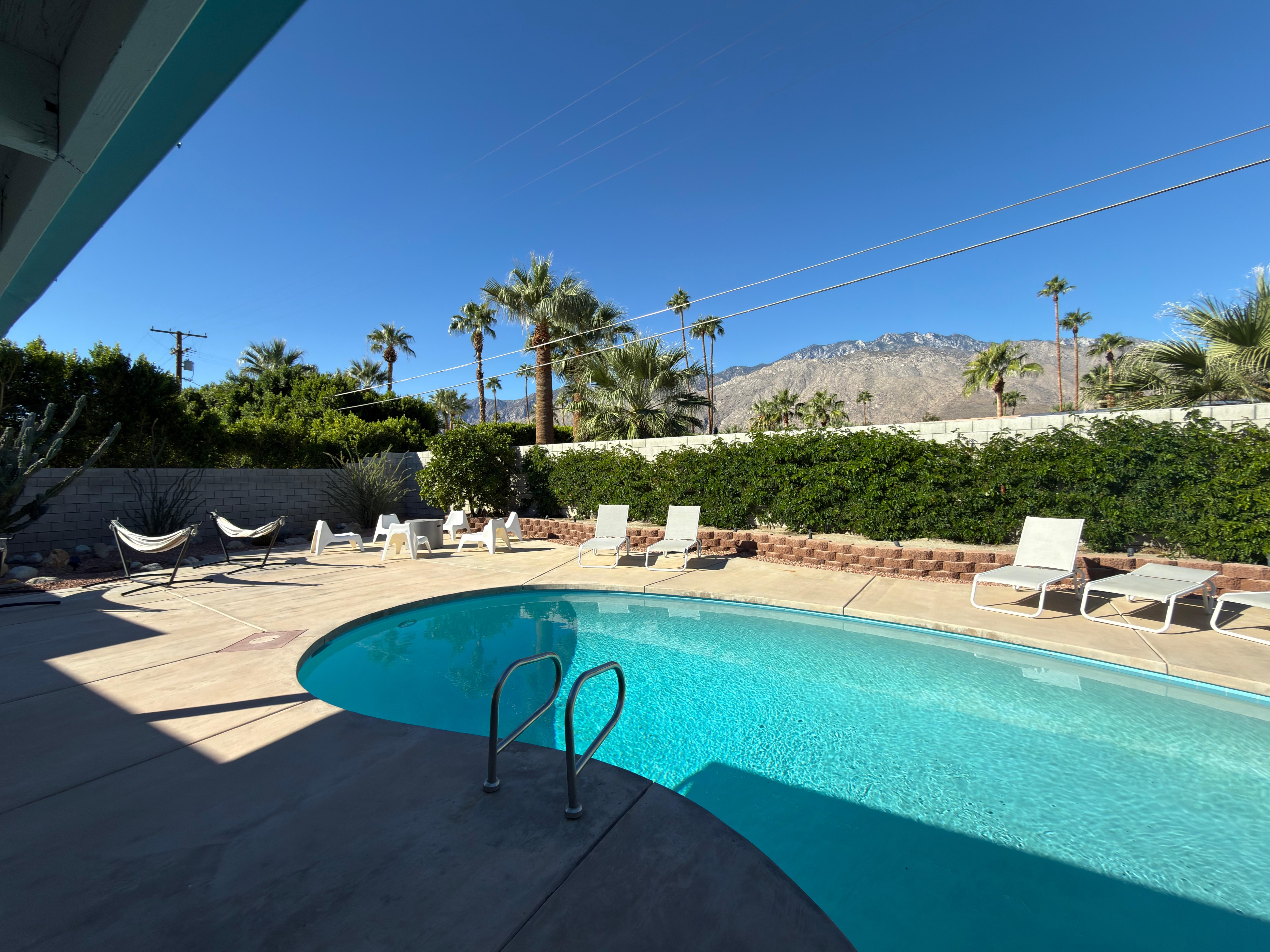 View from the deck of the patio, pool, palms and the arresting view of Mt. San Jacinto