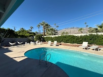 View from the deck of the patio, pool, palms and the arresting view of Mt. San Jacinto